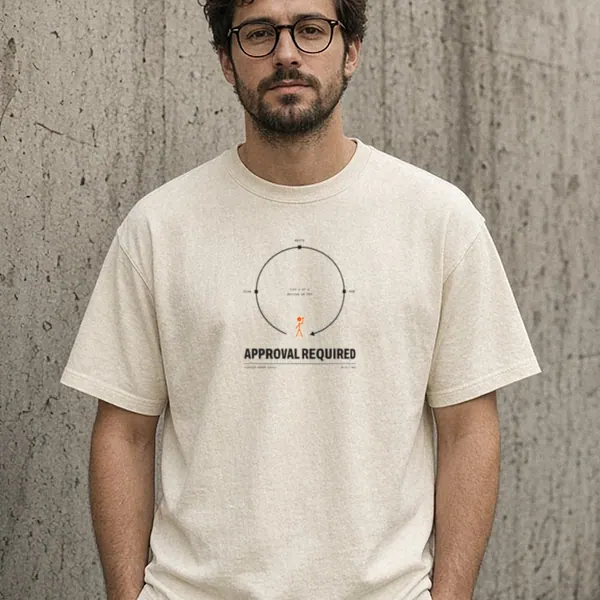 AI-generated render of the Approval Required Tee in Ivory on a model, front view: front print of a loop diagram labeled PLAN, WRITE and RUN with a small orange stick figure, and APPROVAL REQUIRED below.